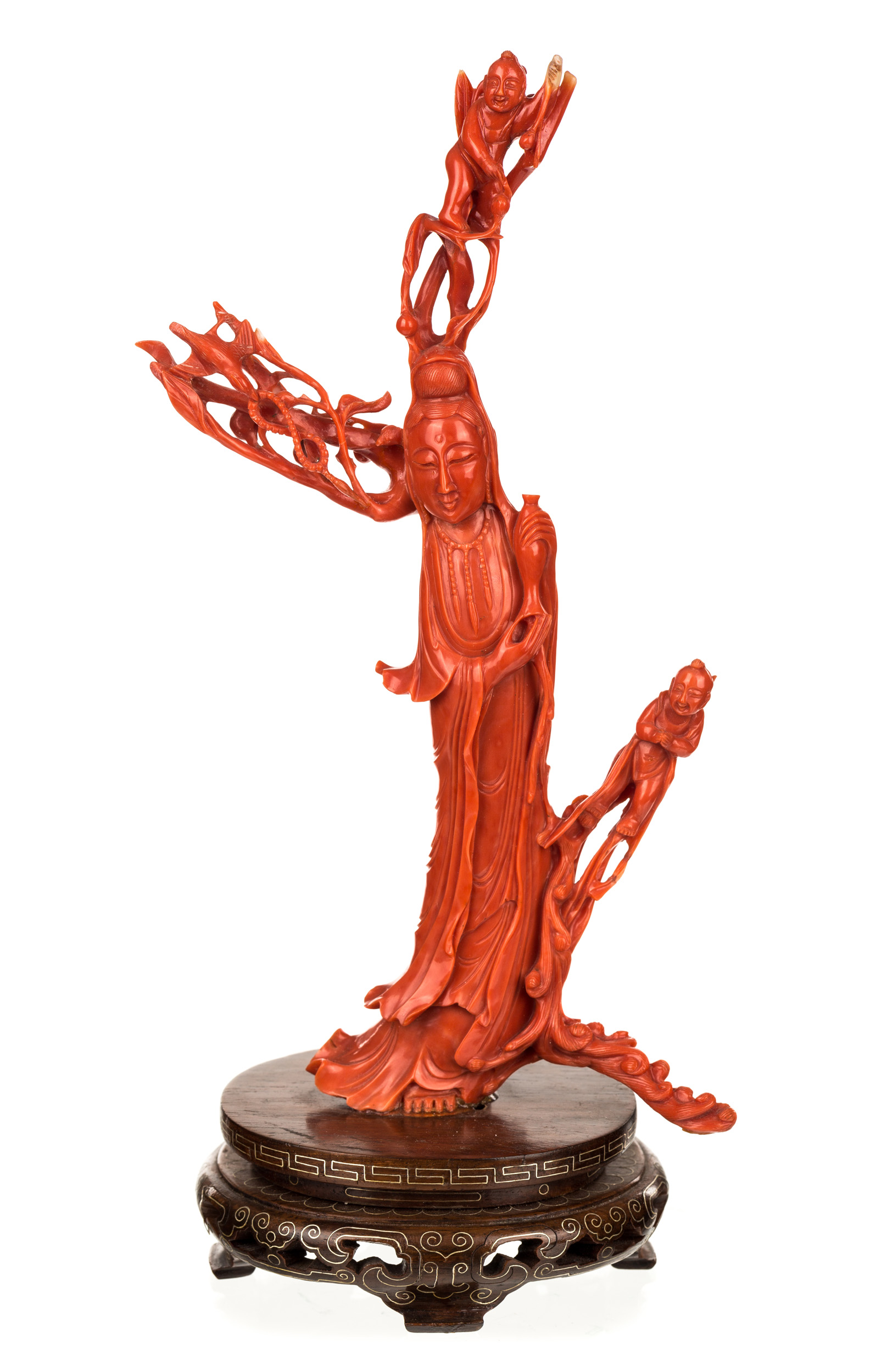 A CHINESE CARVED RED CORAL FIGURE OF A GUANYIN POURING HEALING WATER