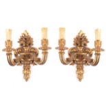 Pair of carved giltwood wall lights each of two scroll arms  37 cm. high; 30 cm. wideWorldwide