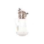 Silver mounted engraved glass claret jug
