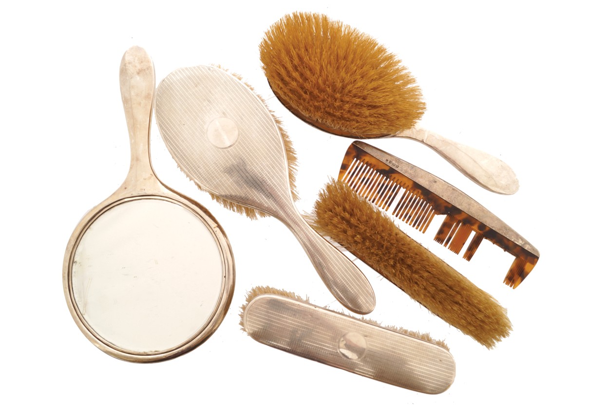 Lot of silver backed brushes, a mirror and together with one comb