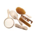 Lot of silver backed brushes, a mirror and together with one comb