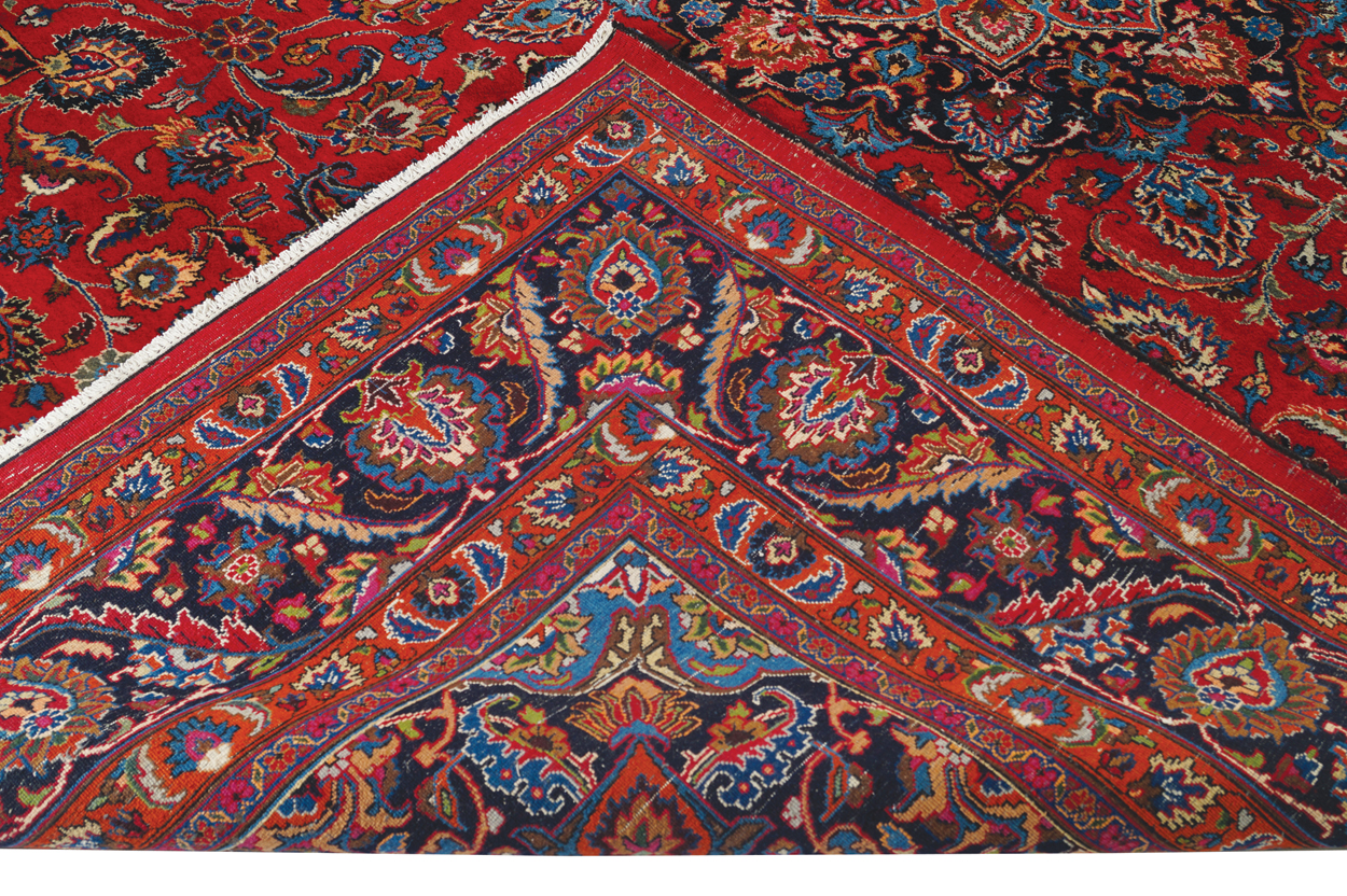 NORTHEAST PERSIAN CARPET on rich red ground with navy border; includes weaver’s signature 402 x - Image 7 of 9