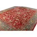 NORTHWEST PERSIAN TABRIZ CARPET on red ground with all over foliage design and turquoise border