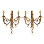 PAIR OF ORMOLU WALL LIGHTS each of two scroll arms surmounted by a cherub blowing trumpets 41 cm.