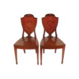 PAIR OF REGENCY PERIOD MAHOGANY ARMORIAL BACKED HALL CHAIRS, CIRCA 1810 each with a panelled seat,