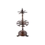 NINETEENTH-CENTURY MAHOGANY AND BRASS BOUND WHIP STAND raised on a circular platform base,