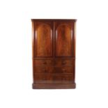 NINETEENTH-CENTURY MAHOGANY LINEN PRESS The moulded crown above two arched panelled doors, over