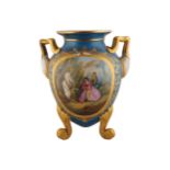 SÈVRES STYLE PARCEL GILT URN with scroll armed handles, framing a painted cartouche depicting