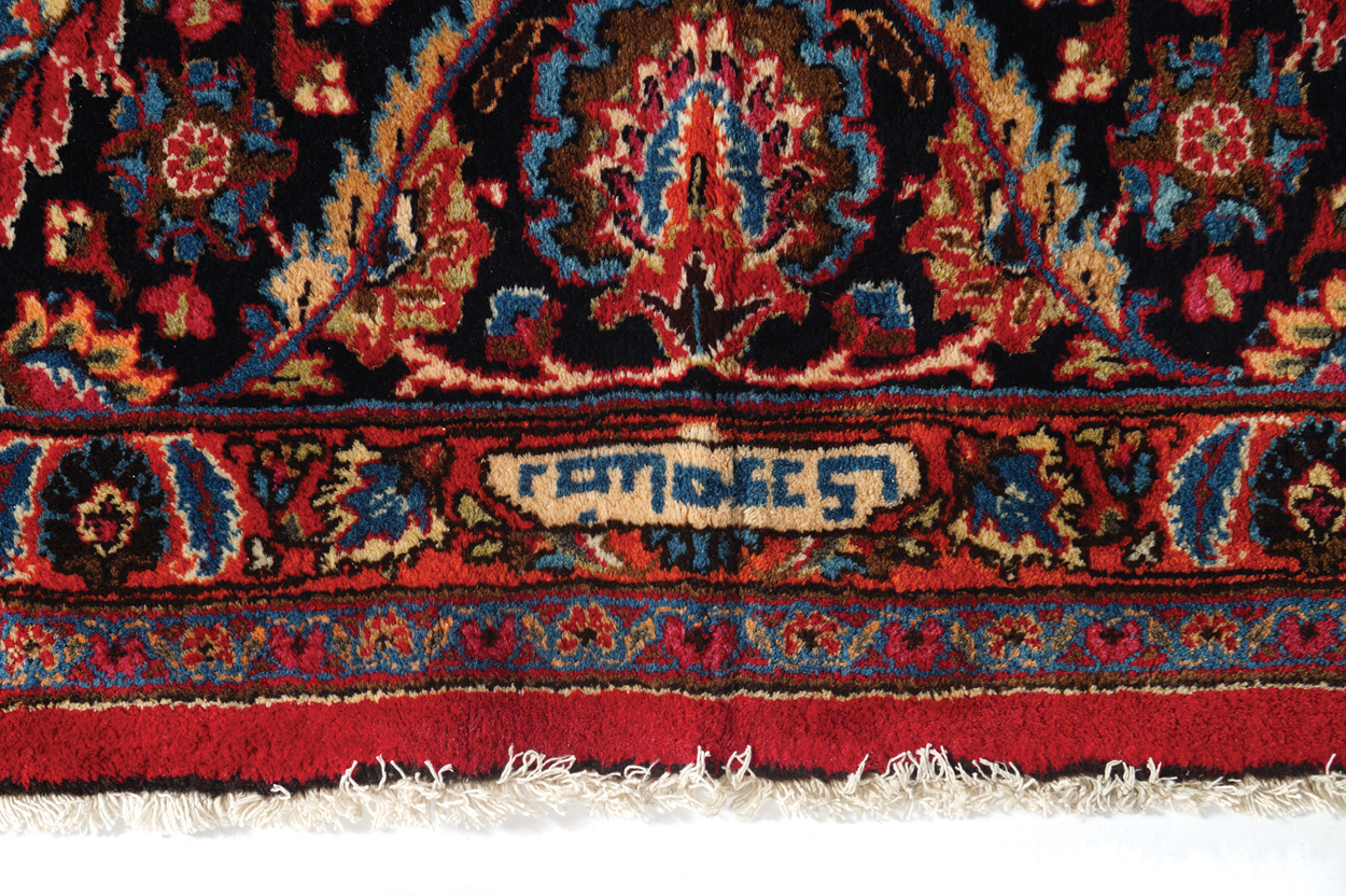 NORTHEAST PERSIAN CARPET on rich red ground with navy border; includes weaver’s signature 402 x - Image 8 of 9