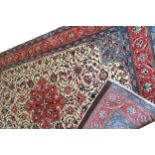 NORTHWEST PERSIAN RUG on ivory ground with red central medallion, red border and blue spandrels