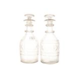 PAIR OF GEORGIAN CUT GLASS DECANTERS each with a triple ring neck 26 cm. high; 10 cm. diameter (2)