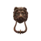 EIGHTEENTH-CENTURY DUBLIN DOOR KNOCKER of laureate form, with lion mask decoration and a grasped,