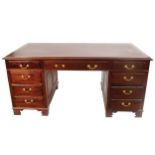GEORGE III STYLE MAHOGANY PEDESTAL WRITING DESK the rectangular leather inset top above a series