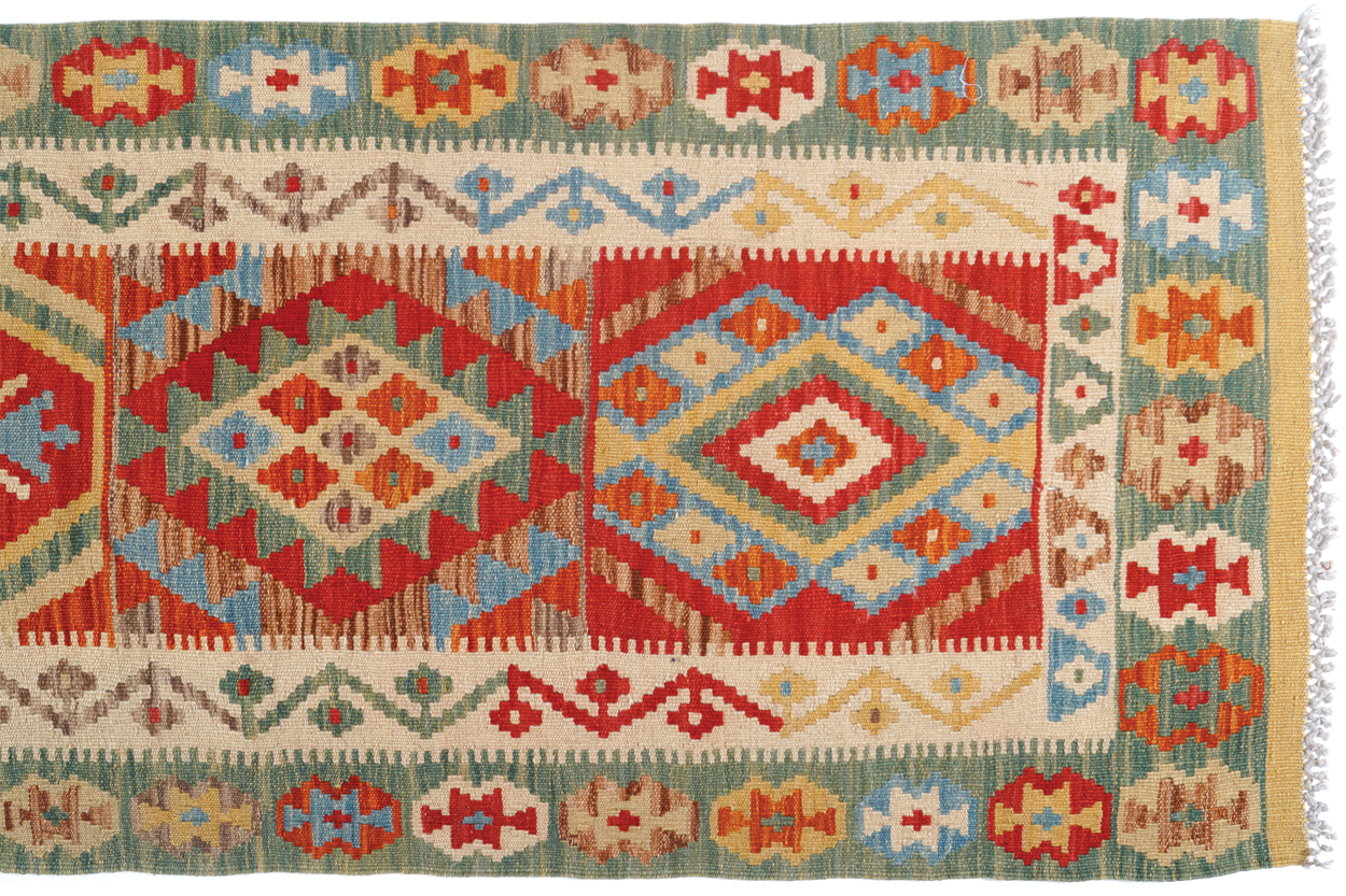 NORTHEAST PERSIAN RUNNER with outer pistachio border and twelve medallions; veg dye 496 x 75 cm.