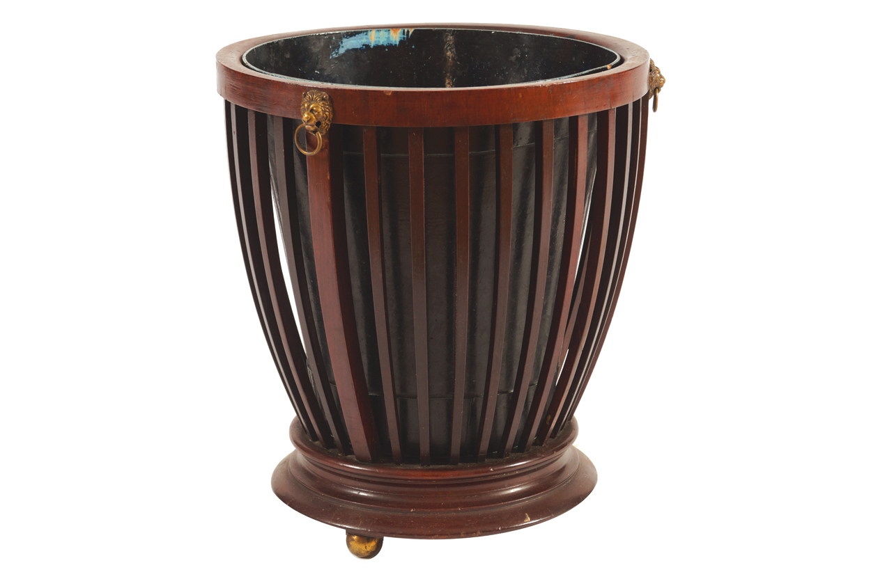EDWARDIAN MAHOGANY PAPER BASKET with lion mask decoration and metal lined interior, raised on