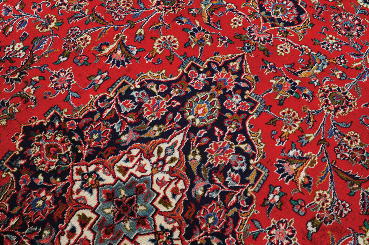 WEST PERSIAN KASHAN CARPET, CIRCA 1930 on red ground with central medallion and navy border 387 x - Image 2 of 6