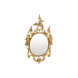 EIGHTEENTH-CENTURY CARVED GILTWOOD MIRROR, CIRCA 1760 the oval plate within a carved foliage and