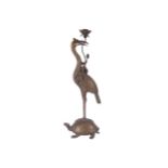 PAIR OF LARGE ORIENTAL BRONZE STORKS each supporting a candleholder and mounted on a turtle 70 cm.