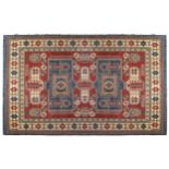 KAZAKH CAUCASIAN CARPET with ivory border and two rectangular blue medallions 327 x 236 cm.