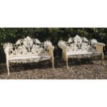 PAIR OF HEAVY ORNATE CAST-IRON GARDEN BENCHES raised on canine mounted scroll ends 153 cm. wide (