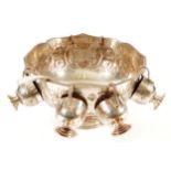 SHEFFIELD PLATED PUNCH BOWL AND GOBLETS with embossed floral decoration, below a gadrooned rim,