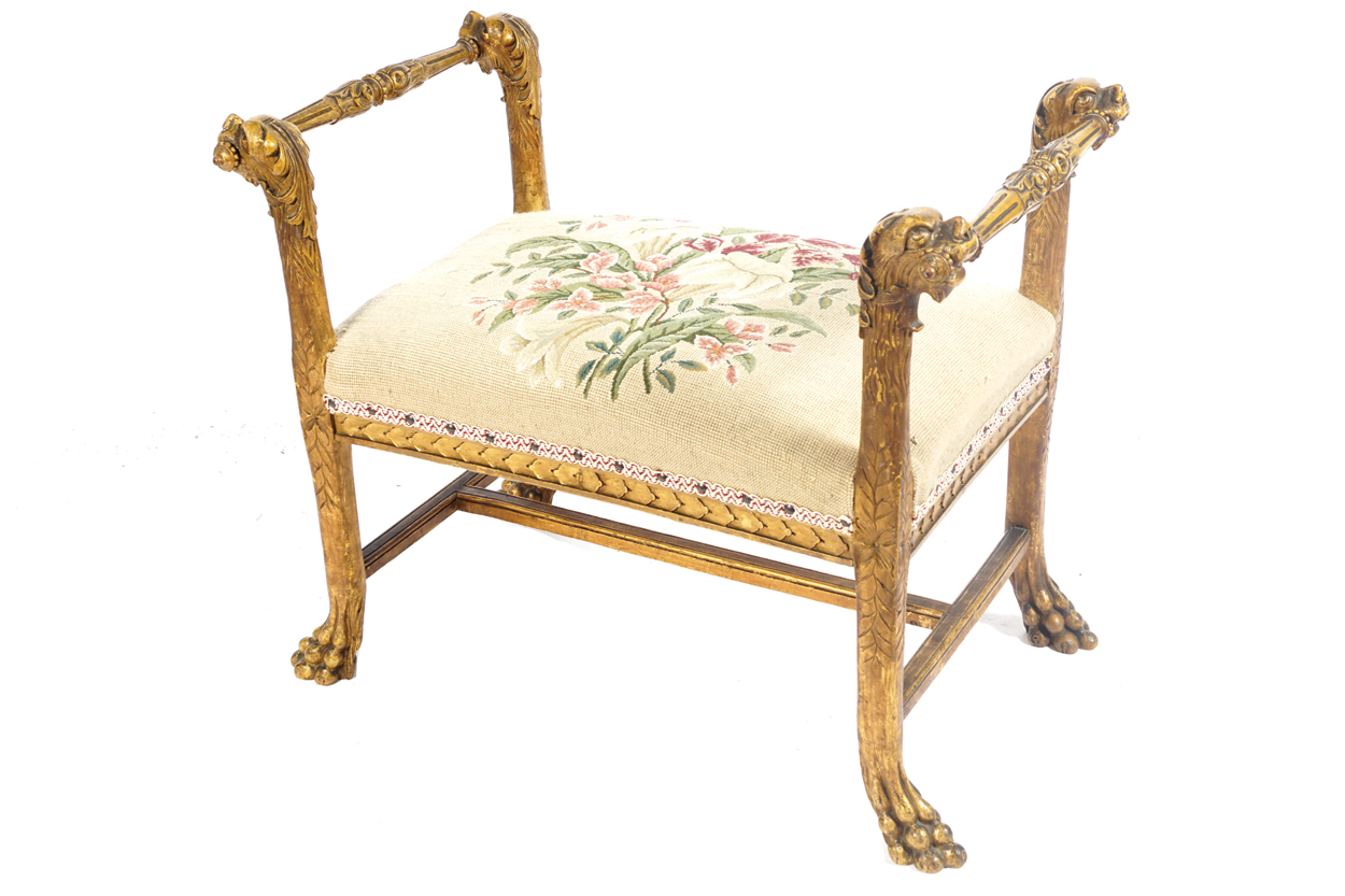 NINETEETH-CENTURY CARVED GILT WOOD WINDOW SEAT the tapestry upholstered seat, between mask headed