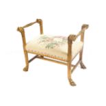 NINETEETH-CENTURY CARVED GILT WOOD WINDOW SEAT the tapestry upholstered seat, between mask headed