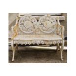 PAIR OF HEAVY CAST IRON GARDEN BENCHES each with a circular panelled back raised on scroll ends. 100