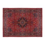 NORTHEAST PERSIAN CARPET on rich red ground with navy border; includes weaver’s signature 402 x