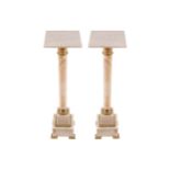 PAIR OF ORMOLU MOUNTED MARBLE PLINTHS each with a square top, raised on a turned column, supported