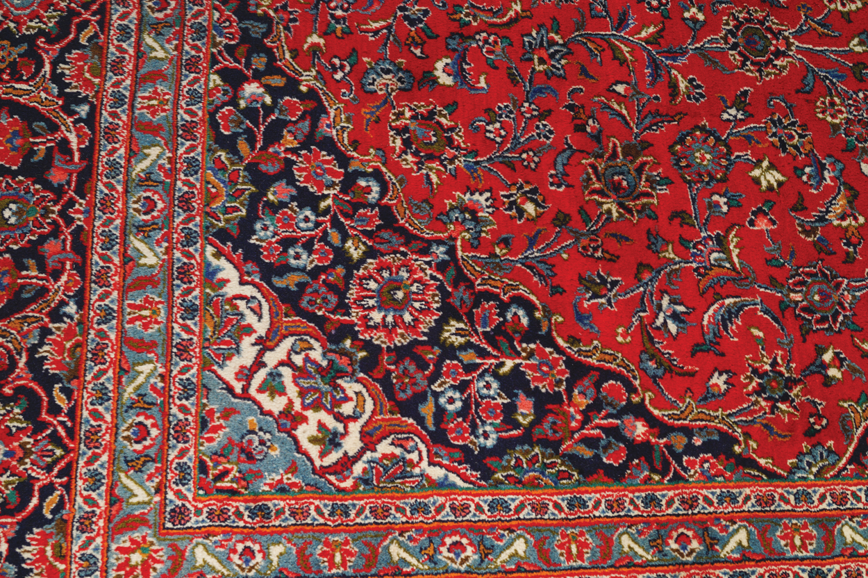 WEST PERSIAN KASHAN CARPET, CIRCA 1930 on red ground with central medallion and navy border 387 x - Image 4 of 6