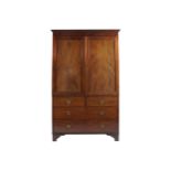 NINETEENTH-CENTURY MAHOGANY LINEN PRESS The moulded crown above two panelled doors, over two