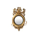 IRISH REGENCY PERIOD GILT FRAMED CONVEX MIRROR, CIRCA 1810 surmounted by a lamb 126 cm. high