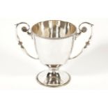 SILVER TROPHY with a ribbed border and scroll handles raised on a circular foot. Dublin 1913. Maker: