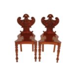 PAIR OF REGENCY PERIOD CRESTED MAHOGANY ARMORIAL BACKED HALL CHAIRS, CIRCA 1820 each with a