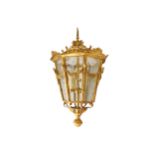 GILDED BRASS HALL LANTERN of hexagonal tapered form with glazed panels, between reeded pillars