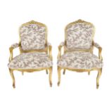 PAIR NINETEENTH-CENTURY CARVED GILTWOOD ARMCHAIRS each with an armorial shaped show frame back,