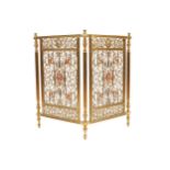 VICTORIAN BRASS FIRE SCREEN of two panels with open work C-scroll decoration centred by a mask 65