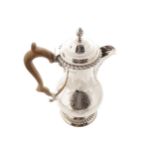 CRESTED SILVER COFFEE POT of baluster form with a gadrooned rim below a domed lid, furnished with