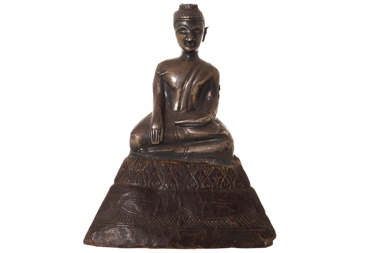NINETEENTH-CENTURY SILVER BUDDHA seated, raised on a composite base 15 cm. high; 11 cm. wide
