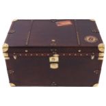 LARGE BRASS MOUNTED LEATHER BOUND TRAVELLING TRUNK furnished with brass carrying handles 50 cm.