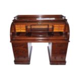 NINETEENTH-CENTURY MAHOGANY ROLL-TOP WRITING DESK the rectangular top below a moulded three