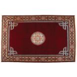 MOROCCAN BERBER CARPET, CIRCA 1940 on red ground with central medallion 196 x 296 cm. Worldwide