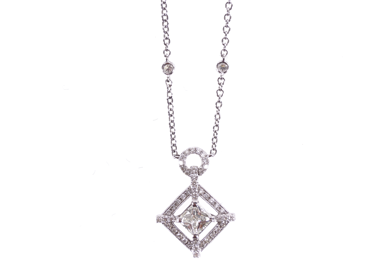 18 CT. WHITE GOLD CHAIN set with six diamonds and a radiant square cut diamond hanging from it,