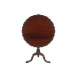 IRISH EIGHTEENTH-CENTURY MAHOGANY SNAP TOP SILVER TABLE the circular pie crust and shell carved