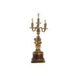 PAIR OF ORMOLU AND ROUGE ROYAL MARBLE CHERUB STEMMED CANDELABRAS each of four lights 65 cm. high; 24