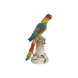 LARGE DRESDEN POLYCHROME PARROT raised on a stylised tree trunk 46 cm. high