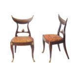 PAIR OF NIENTEENTH-CENTURY ORMOLU MOUNTED CRESCENT BACK CHAIRS each with a panelled upholstered