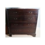 GEORGE III PERIOD MAHOGANY CHEST of four long drawers, furnished with brass handles, raised on