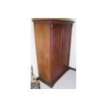 WILLIAM IV PERIOD MAHOGANY WARDROBE the moulded crown above two panelled doors, between pillars,